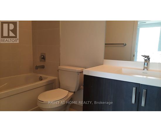 A bathroom with a toilet, sink, and bathtub.