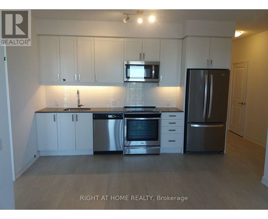 A kitchen with white cabinets and stainless steel appliances.
