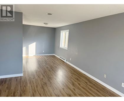 A room with wooden flooring and a window.