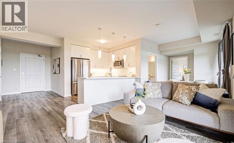 A modern living room with a grey sofa and a white coffee table.