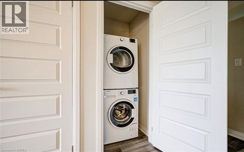 A washer and dryer are stacked in a small space.