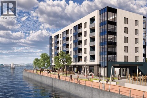 A modern building with a glass facade is situated by a body of water.