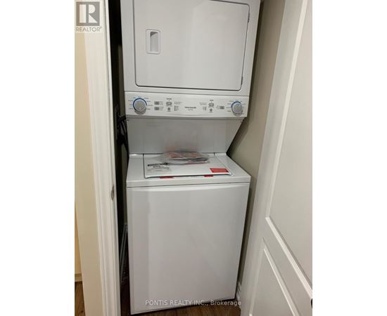 A white dryer and washer are in a small space.