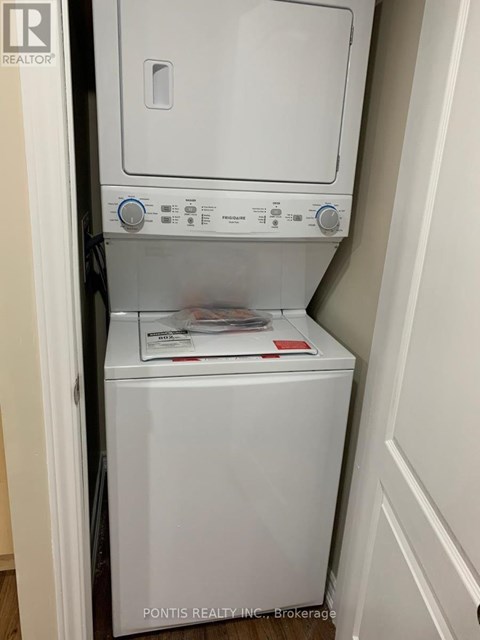 A white dryer and washer are in a small space.