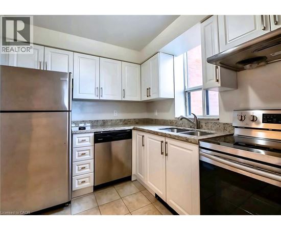 A kitchen with white cabinets and stainless steel appliances.