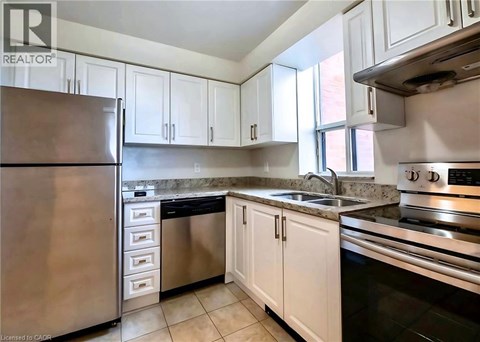A kitchen with white cabinets and stainless steel appliances.