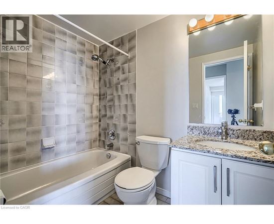 A bathroom with a tub, toilet and sink.