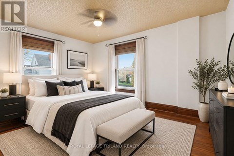 A bedroom with a large bed and a window with a view of the outside.
