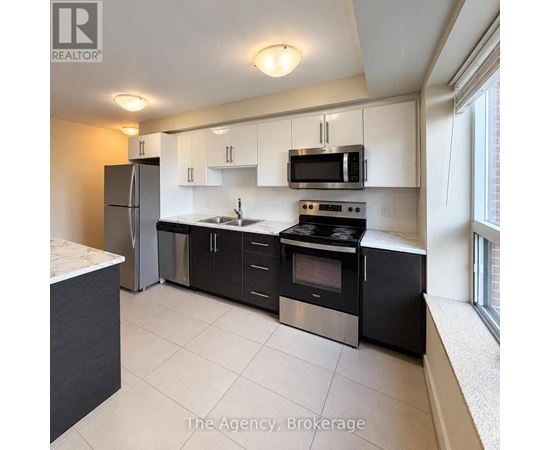 A kitchen with black appliances and white cabinets.