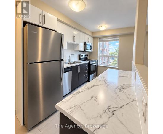 A kitchen with a marble counter top and stainless steel appliances.
