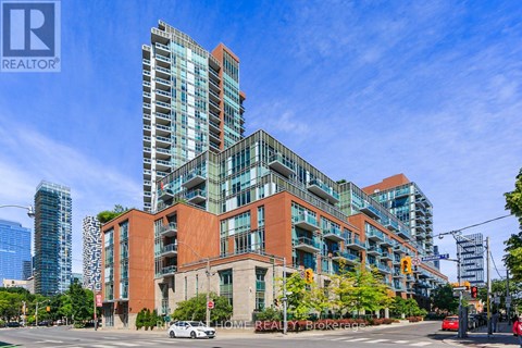 A modern multi-story building with a glass facade is the main focus of the image.