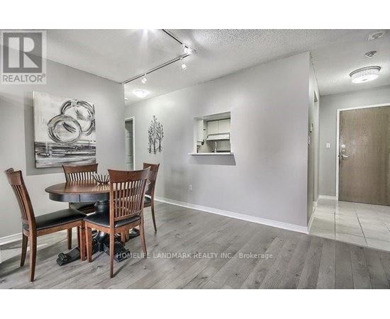 A dining room with a table and chairs.