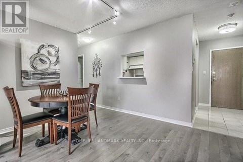 A dining room with a table and chairs.