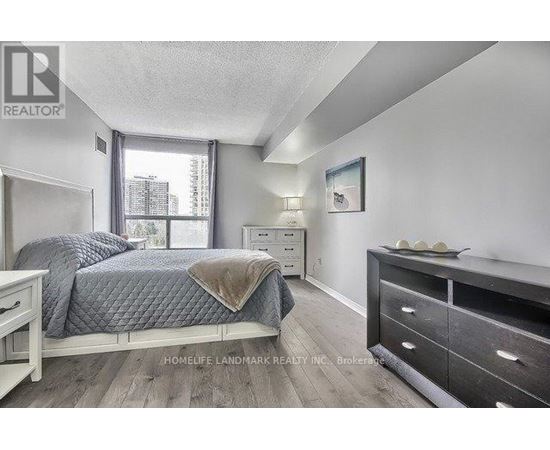 A bedroom with a bed, nightstand, and dresser.