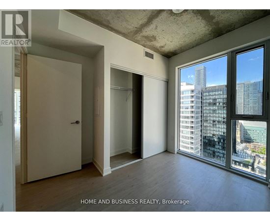 A room with a view of the city through large windows.