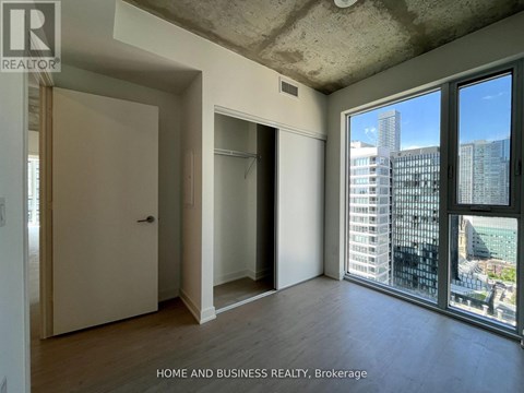 A room with a view of the city through large windows.