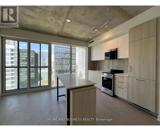 A modern kitchen with wooden cabinets and a large island.