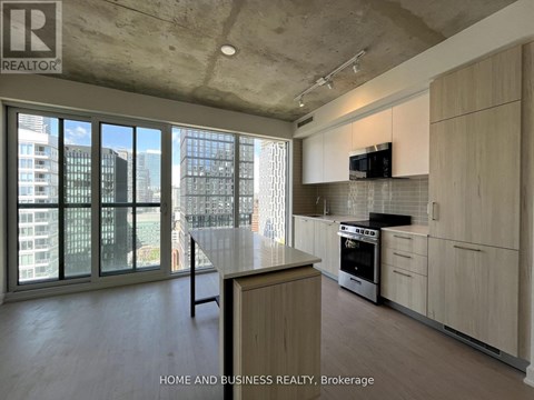 A modern kitchen with wooden cabinets and a large island.