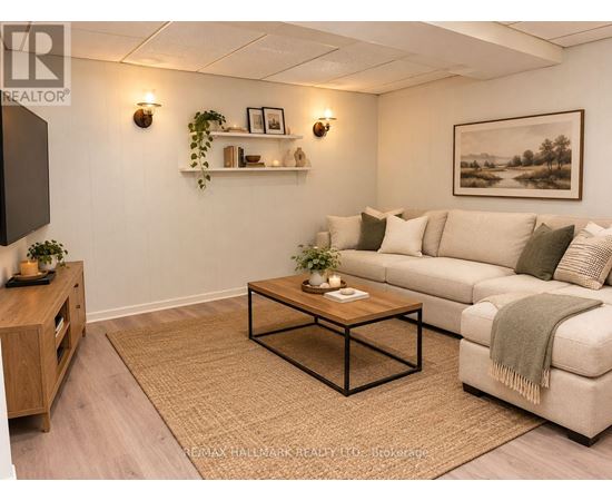 A living room with a couch, coffee table, and a painting on the wall.