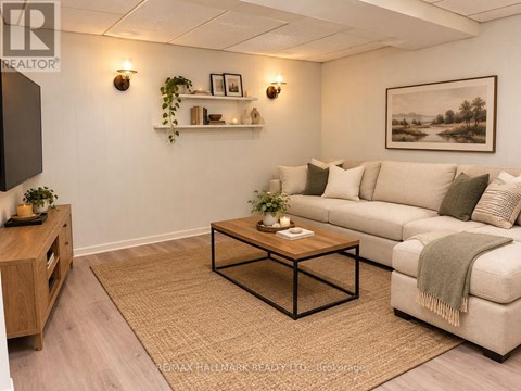 A living room with a couch, coffee table, and a painting on the wall.
