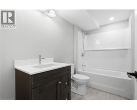 A bathroom with a toilet, sink, and bathtub.