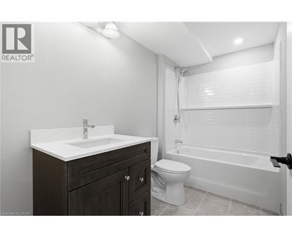 A bathroom with a toilet, sink, and bathtub.