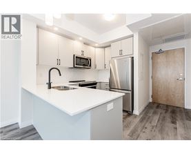 A kitchen with a white counter top and stainless steel appliances.