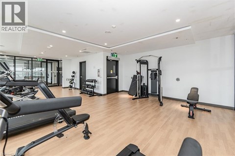 A gym with a variety of equipment including treadmills, weights, and exercise machines.
