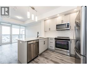 A modern kitchen with stainless steel appliances and white cabinets.