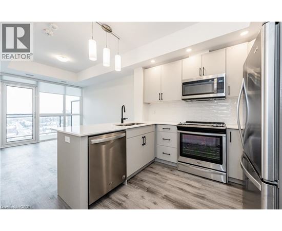 A modern kitchen with stainless steel appliances and white cabinets.