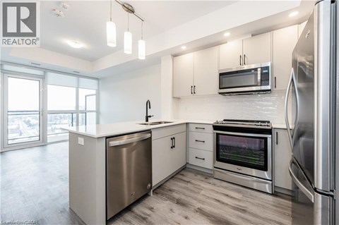 A modern kitchen with stainless steel appliances and white cabinets.