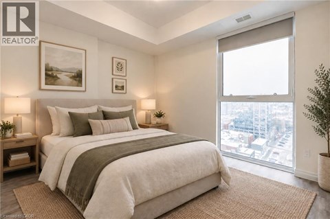 A bedroom with a large bed and a view of the city.