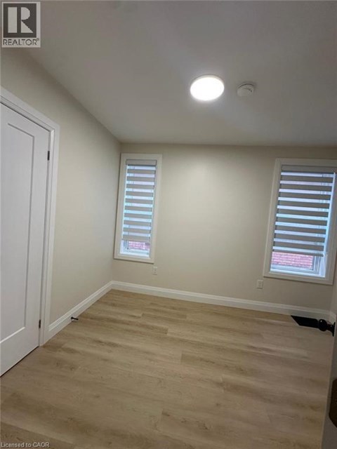 A room with a white door and a window with blinds.