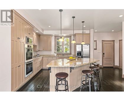 A kitchen with wooden cabinets and a marble countertop.