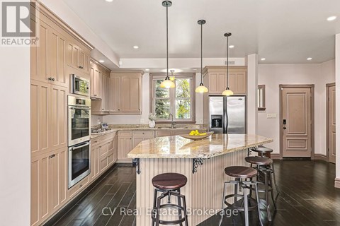 A kitchen with wooden cabinets and a marble countertop.