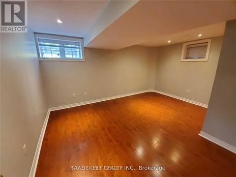 A room with a wooden floor and a window.