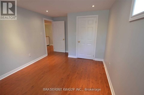 A room with a wooden floor and white walls.