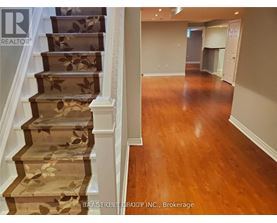 A staircase with a floral patterned runner and wooden steps.