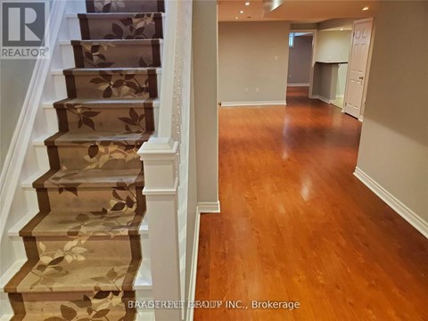 A staircase with a floral patterned runner and wooden steps.