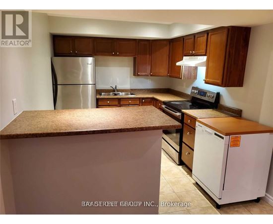 A kitchen with a refrigerator, stove, and cabinets.