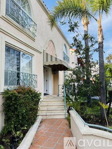 A house with a palm tree in front.