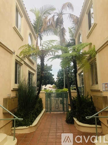 A building with a gate and plants in front.