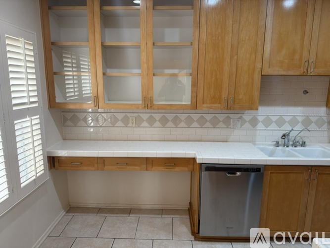 A kitchen with wooden cabinets and a white countertop.