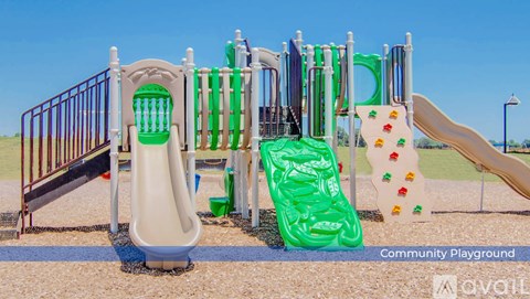 A playground with a slide, swings, and a climbing frame.