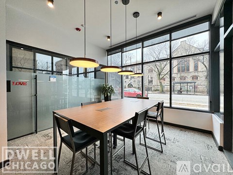 A modern dining room with a wooden table and chairs.
