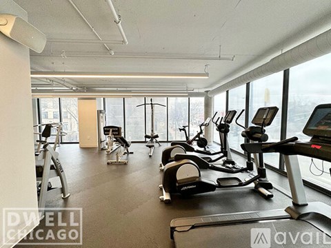 A gym with treadmills, elliptical machines, and other exercise equipment.