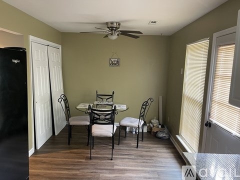 A dining room with a table set for four.