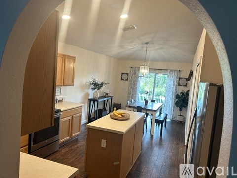 A kitchen with wooden cabinets and a refrigerator.