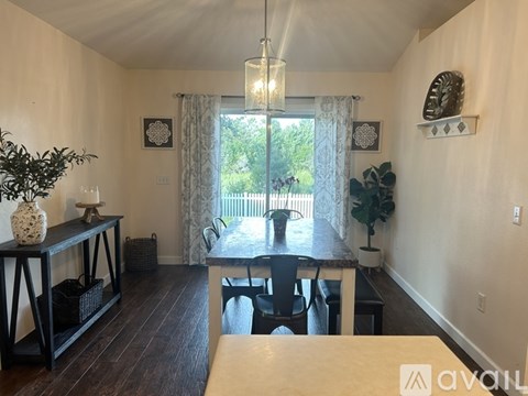 A dining room with a table and chairs.