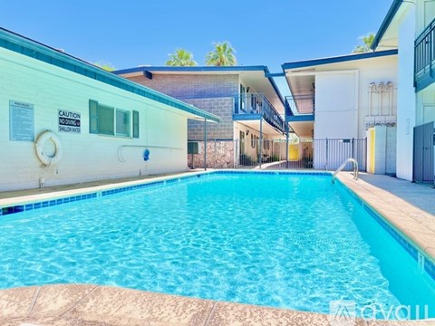 A pool with a caution sign on the wall.